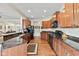 Well-equipped kitchen with granite countertops and wood cabinets, adjacent to the living space at 13327 Hockley Dr, Fishers, IN 46037