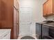 Bright laundry room with tile floor, cabinetry, utility sink, and stainless steel washer and dryer set at 13327 Hockley Dr, Fishers, IN 46037