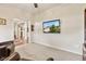 Cozy living room with carpet, wall-mounted TV, and seamless transition to adjacent spaces at 13327 Hockley Dr, Fishers, IN 46037