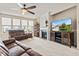 Bright living room featuring a fireplace, large windows, and comfortable seating at 13327 Hockley Dr, Fishers, IN 46037