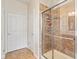 Shower features glass doors and tile surround at 13327 Hockley Dr, Fishers, IN 46037