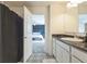 Bathroom featuring modern vanity, tub-shower combo with view of the bedroom at 1381 Delacorte Cir, Shelbyville, IN 46176