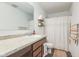 Well-lit bathroom featuring a sink vanity and shower with white curtain at 1381 Delacorte Cir, Shelbyville, IN 46176