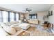 A living room with hardwood floors, a ceiling fan, a TV, and modern furniture at 1381 Delacorte Cir, Shelbyville, IN 46176