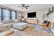 A living room with hardwood floors, a ceiling fan, a TV, and modern furniture at 1381 Delacorte Cir, Shelbyville, IN 46176