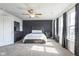 An elegant main bedroom with a ceiling fan, accent wall, dresser, and windows with natural lighting at 1381 Delacorte Cir, Shelbyville, IN 46176