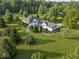 Stunning aerial view of an estate home, set amidst lush greenery and mature trees at 14301 W County Road 300 S, Daleville, IN 47334