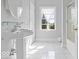 Bright, spacious bathroom featuring a sleek pedestal sink, white tiled floors, and walk-in shower at 14301 W County Road 300 S, Daleville, IN 47334