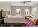 This bedroom features a wooden frame bed, carpet flooring, and a tan-colored sofa at 14301 W County Road 300 S, Daleville, IN 47334