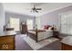 Charming bedroom featuring a four-poster bed, plush rug, and three windows for natural light at 14301 W County Road 300 S, Daleville, IN 47334