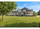 A grand home with an attached 3-car garage, inviting porch, and extensive front yard at 14301 W County Road 300 S, Daleville, IN 47334