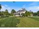 Picturesque two-story home with a sprawling green lawn, mature trees, and a classic gazebo at 14301 W County Road 300 S, Daleville, IN 47334