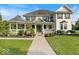 Charming two-story home with a welcoming porch, manicured lawn and landscaped garden beds at 14301 W County Road 300 S, Daleville, IN 47334