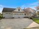 Spacious three-car garage with a large driveway and well-maintained landscaping at 14301 W County Road 300 S, Daleville, IN 47334