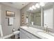 Bathroom featuring double sinks, granite countertop, and framed mirror over white cabinetry at 14442 Treasure Creek Ln, Fishers, IN 46038