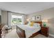 Bright bedroom featuring a wood sleigh bed, carpet and large window with scenic outdoor view at 14442 Treasure Creek Ln, Fishers, IN 46038