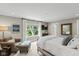 Bedroom with a large window, TV, comfortable armchair, and a plush white bed at 14442 Treasure Creek Ln, Fishers, IN 46038