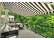 Outdoor deck features awning, a glass railing, and a forest view at 14442 Treasure Creek Ln, Fishers, IN 46038