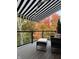 The deck's awning provides shade while enjoying the scenic fall foliage and a comfortable seating area at 14442 Treasure Creek Ln, Fishers, IN 46038