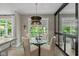 Charming dining area with a glass table, comfortable chairs, and a view of the outdoors at 14442 Treasure Creek Ln, Fishers, IN 46038