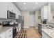 Well-equipped kitchen featuring stainless steel appliances, granite countertops, and wood flooring at 14442 Treasure Creek Ln, Fishers, IN 46038