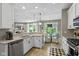 Modern kitchen with stainless steel appliances, granite countertops, and open-concept design at 14442 Treasure Creek Ln, Fishers, IN 46038