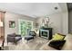 Relaxing living room boasts a fireplace, ample seating, and a scenic backyard view at 14442 Treasure Creek Ln, Fishers, IN 46038