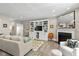 Cozy living room with built-in shelving, a fireplace, and comfortable seating area at 14442 Treasure Creek Ln, Fishers, IN 46038