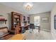 Home office with a large built-in bookshelf desk, leather couch, ottoman and neutral carpet at 14442 Treasure Creek Ln, Fishers, IN 46038