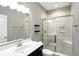 Bathroom featuring tiled shower with glass door, single sink, and sleek fixtures at 14474 Treasure Creek Ln, Fishers, IN 46038