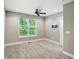 Neutral bedroom with window, ceiling fan, carpet, and blank wall ready for decor at 14474 Treasure Creek Ln, Fishers, IN 46038