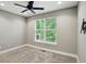 Cozy bedroom with a window, carpet floors, and a ceiling fan, ready for a relaxing retreat at 14474 Treasure Creek Ln, Fishers, IN 46038