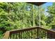 Secluded wooden deck surrounded by lush green trees and vegetation at 14474 Treasure Creek Ln, Fishers, IN 46038