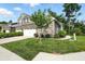 Charming home featuring a well-manicured lawn, mature landscaping, and brick accents at 14474 Treasure Creek Ln, Fishers, IN 46038