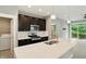 Modern kitchen with stainless appliances, dark cabinets, island with sink, and washer and dryer at 14474 Treasure Creek Ln, Fishers, IN 46038