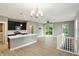 A modern kitchen with stainless steel appliances, dark cabinetry, light countertops, and wood flooring at 14474 Treasure Creek Ln, Fishers, IN 46038