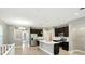Modern kitchen with stainless appliances, dark cabinets, island with sink, and light countertops at 14474 Treasure Creek Ln, Fishers, IN 46038