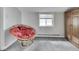 Bright attic room with unique chair, window, and carpet flooring at 1532 E Markwood Ave, Indianapolis, IN 46227