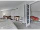 Bright, carpeted attic with a bed, desk, chair, and cozy seating area at 1532 E Markwood Ave, Indianapolis, IN 46227