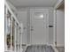 Bright entryway featuring a stylish front door, white trim, and a staircase at 1532 E Markwood Ave, Indianapolis, IN 46227