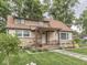 Charming home featuring stone accents, a covered porch, and meticulously landscaped front yard at 1532 E Markwood Ave, Indianapolis, IN 46227