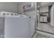 Well-lit laundry room with washer, dryer, and storage shelves for household supplies at 1532 E Markwood Ave, Indianapolis, IN 46227