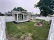 Large fenced backyard with fire pit, garden boxes, and well-maintained landscaping at 1556 N Euclid Ave, Indianapolis, IN 46201
