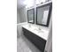 Elegant bathroom with double sinks, dark wood vanity, and large framed mirrors at 1556 N Euclid Ave, Indianapolis, IN 46201