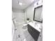 Well-lit bathroom featuring modern vanity, shower-tub combo, and tile flooring at 1556 N Euclid Ave, Indianapolis, IN 46201
