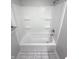 A clean bathtub and shower combination, featuring a standard shower head and built-in shelving at 1556 N Euclid Ave, Indianapolis, IN 46201