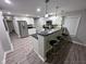 Modern kitchen with stainless steel appliances, white cabinets, and island with bar stool seating at 1556 N Euclid Ave, Indianapolis, IN 46201