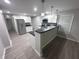 Bright kitchen features stainless steel appliances, white cabinets, and a breakfast bar at 1556 N Euclid Ave, Indianapolis, IN 46201