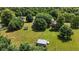 Aerial view of the property and backyard, with a red barn, trampoline and plenty of lush trees at 17138 Joliet Rd, Westfield, IN 46074