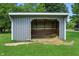 Image shows the outside of a small barn building with an open front and hay inside, on a green lawn area at 17138 Joliet Rd, Westfield, IN 46074